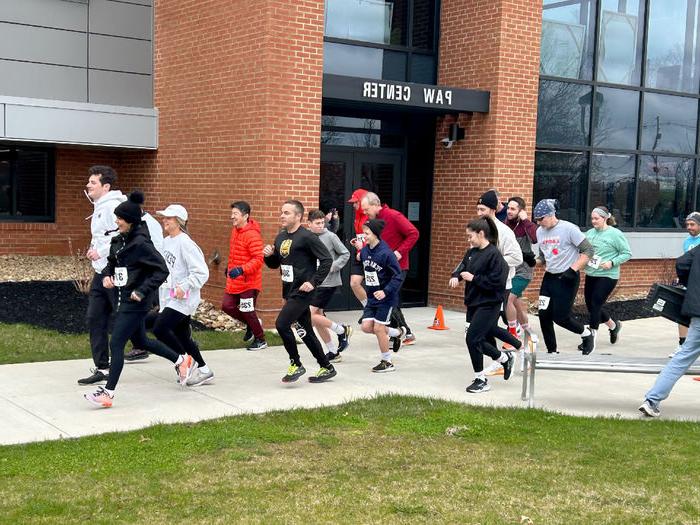 Participants in the Lion 5K Run/Walk cross the starting line near the PAW Center. The 5K took place as part of We Are Weekend at Penn State DuBois.